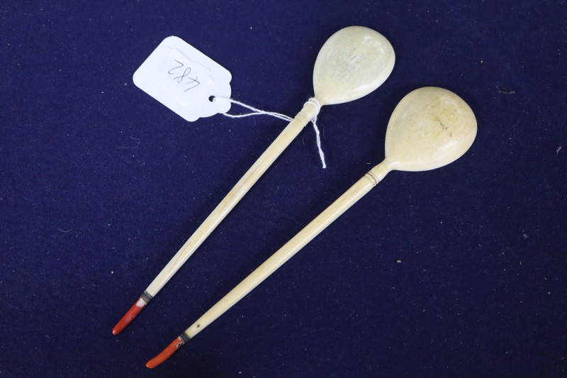 Two Ottoman walrus ivory and coral mounted sherbert spoons, Turkey, 19th century, 21.5cm